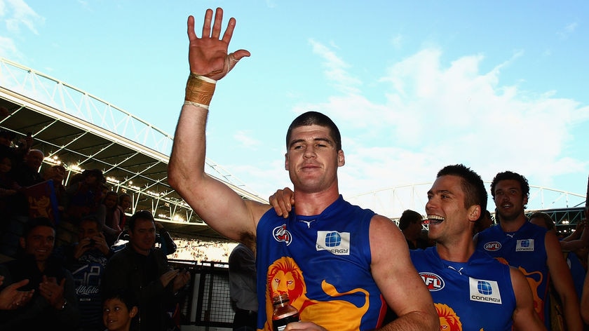 Jonathan Brown celebrates after kicking four goals and registering victory