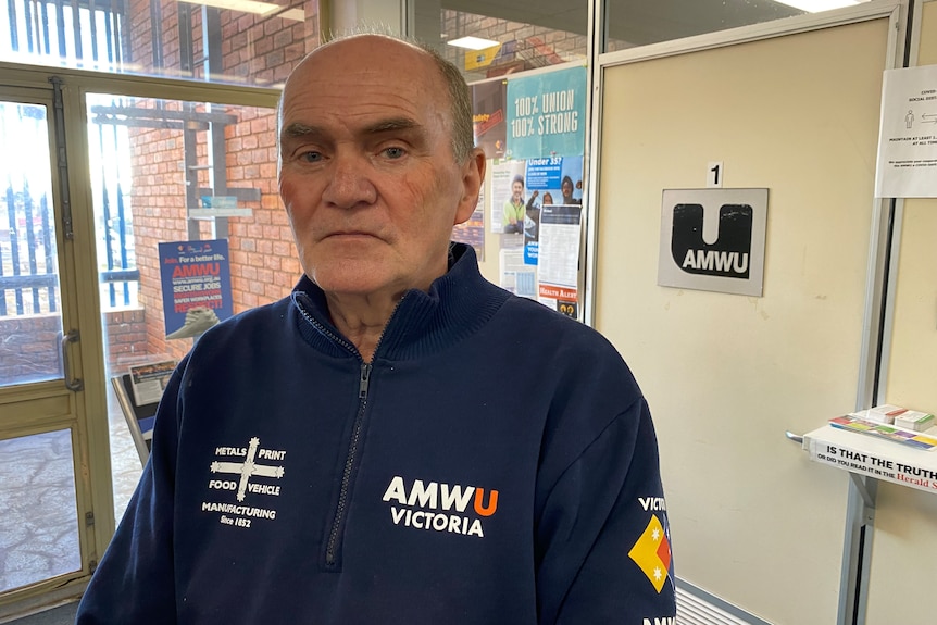 A bald man wearing an AMWU jacket