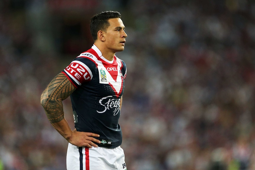 A Sydney Roosters NRL player stands with his hands on his hips during the 2013 NRL grand final.