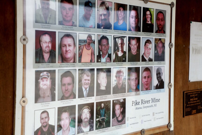 An image of a noticeboard with the small headshots of all the men killed at Pike River 
