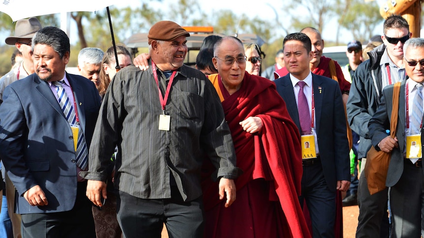 The Dalai Lama is greeted on his arrival at Uluru.