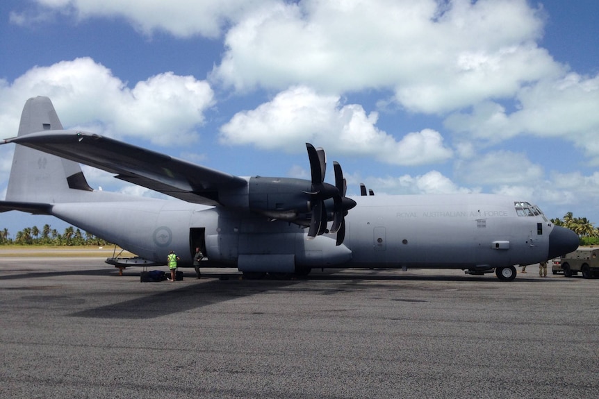 An RAAF C130 Hercules parked at the Cocos Island's airfield as part of the Battle of Cocos centenary commemorations in 2014.