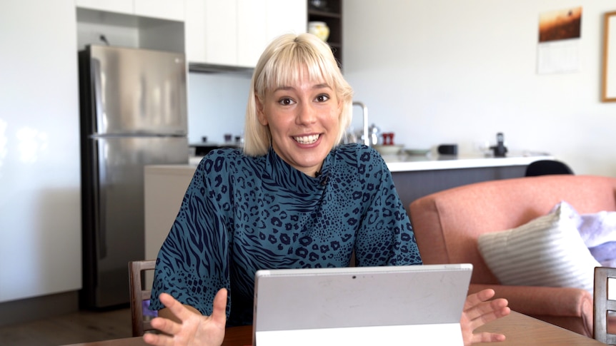 Writer and presenter Sally Coleman sitting in front of a computer, in a story about why she doesn't want life insurance.