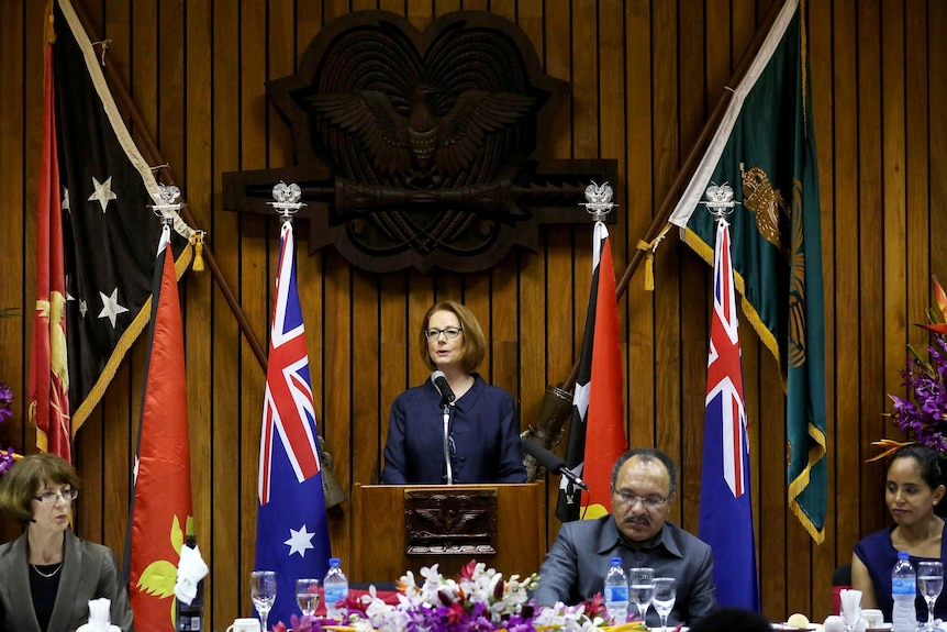 Julia Gillard speaks as Peter O'Neill listens.