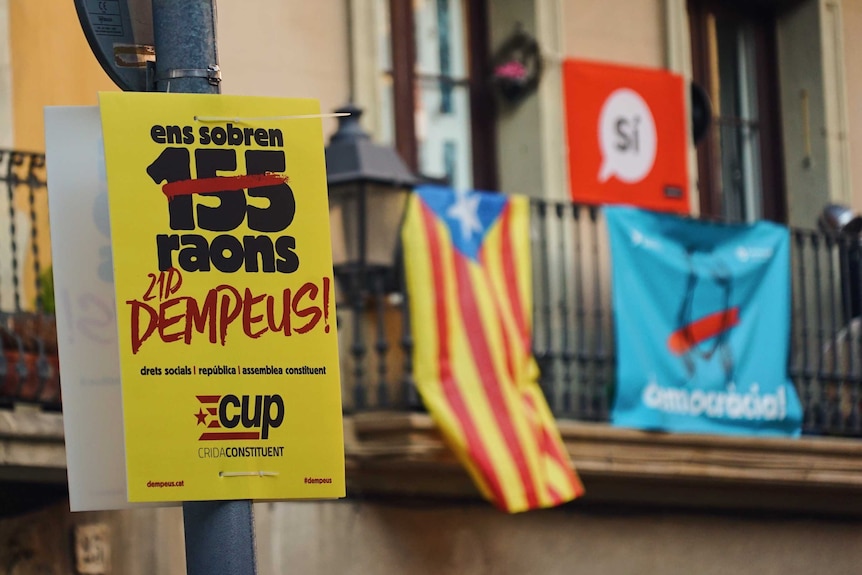 Colourful election posters in Barcelona in front of the Catalan flag ahead of the Catalan regional election.