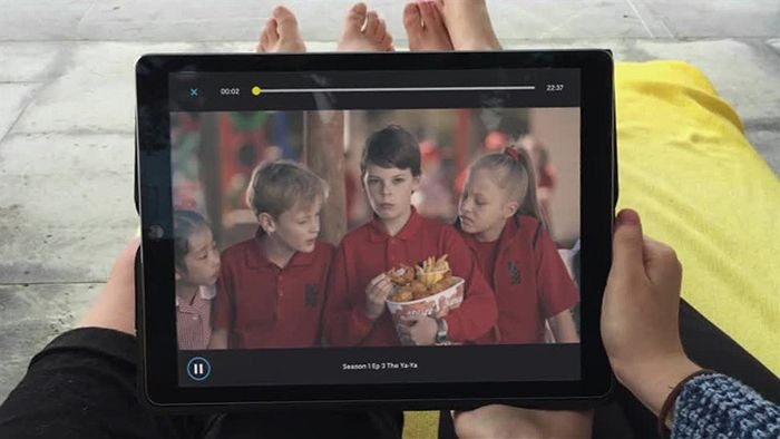 Child holding iPad watching Little Lunch on ABC ME App