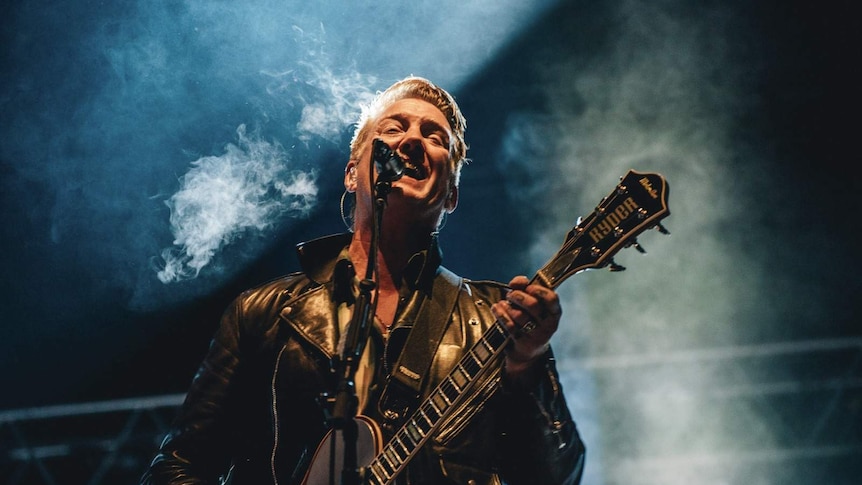 close up image of josh homme on stage performing at splendour in the grass 2107