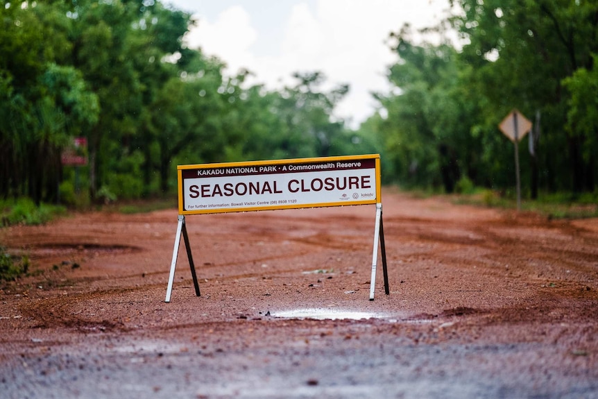 A sign that reads seasonal closure on a dirt track in Kakadu.