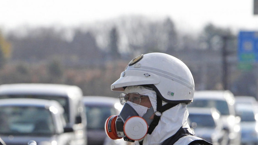Police officers guide people to evacuate away from the Fukushima Daiichi nuclear plant