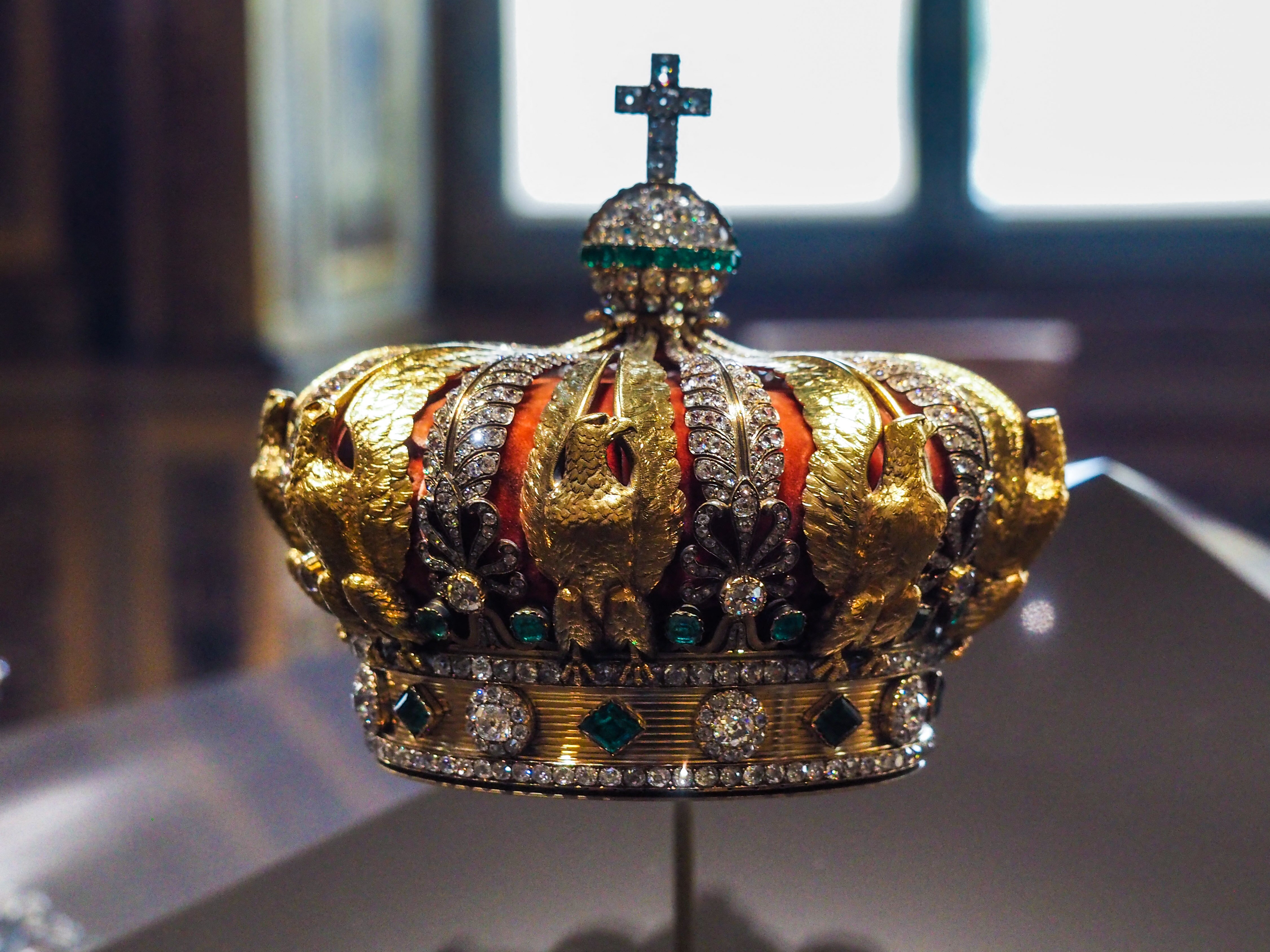 A gold and red crown with gems on it.