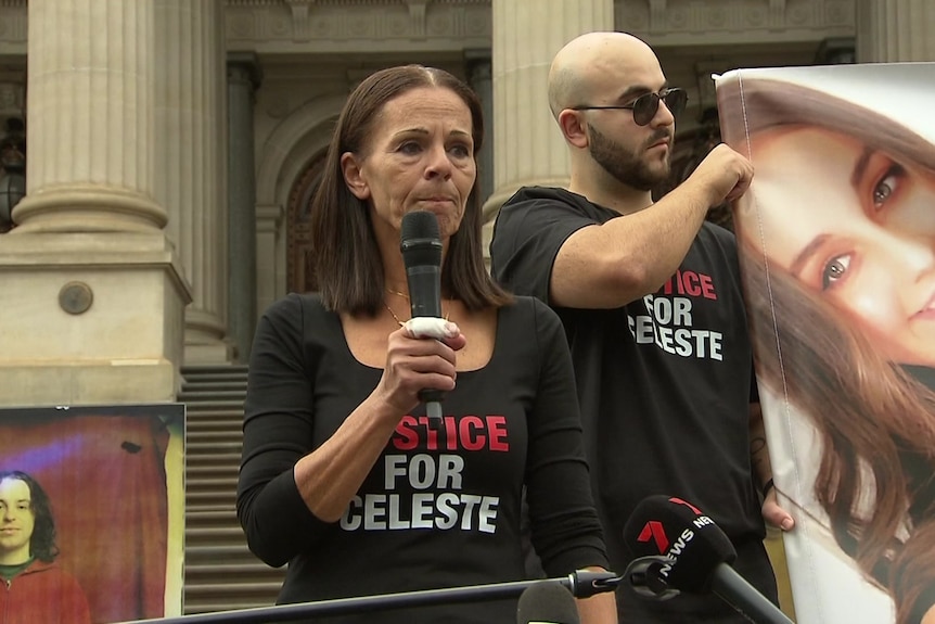 Middle-aged woman speaking into a microphone outside Victoria's Parliament House