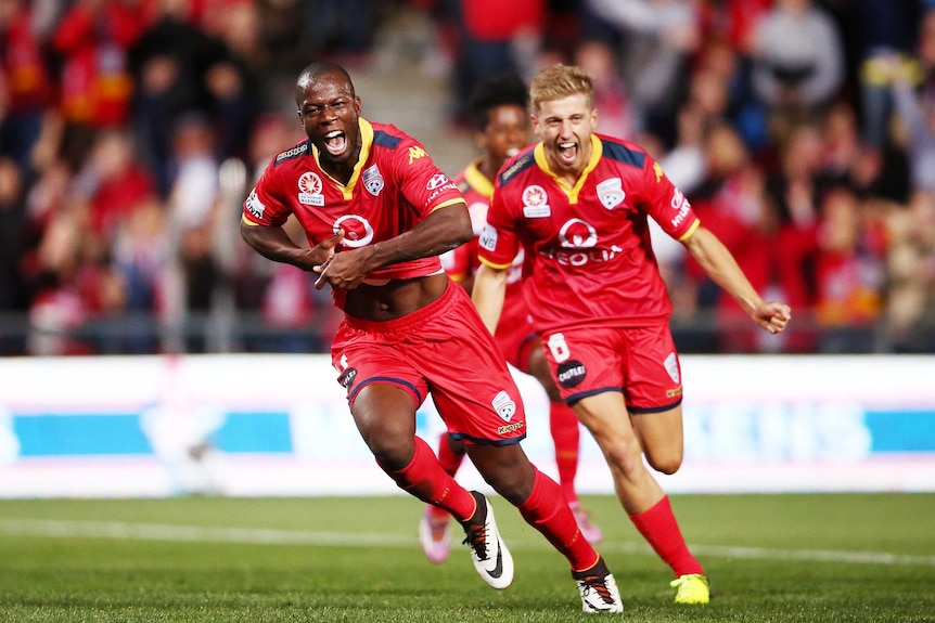 Adelaide's Bruce Djite (L) celebrates a goal in the A-League semi-final against Melbourne City.