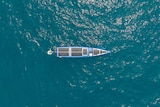 top view of a vessel which looks like a yacht in blue water