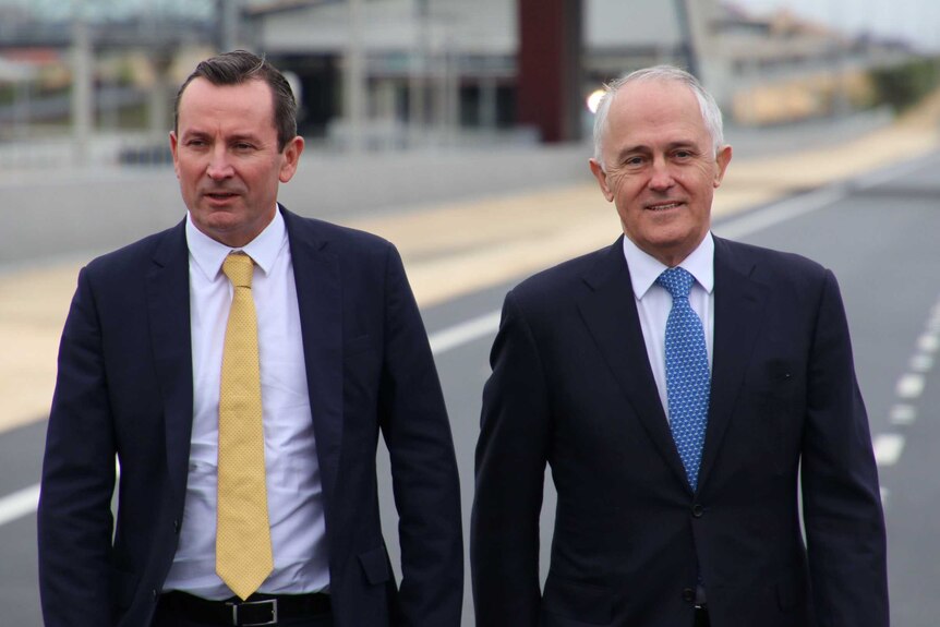 Mid-shot of PM Malcolm Turnbull with WA Premier Mark McGowan walking along a road.