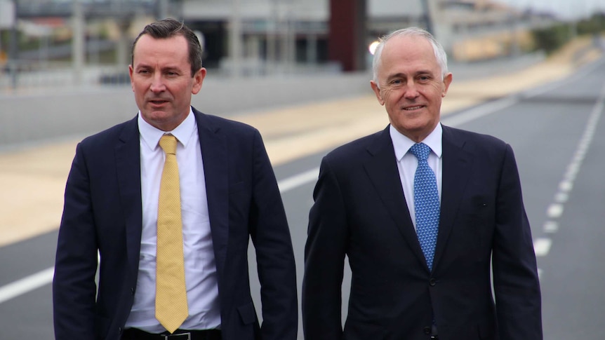 Mid-shot of PM Malcolm Turnbull with WA Premier Mark McGowan walking along a road.