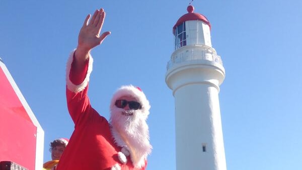 Santa on a fire truck in front of the Aireys Inlet lighthouse