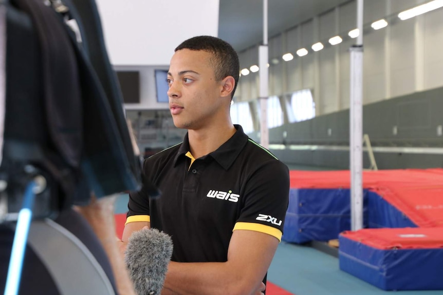 An athlete waits for the next question at a press conference.