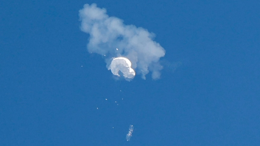 The suspected Chinese spy balloon drifts to the ocean after being shot down off the coast in Surfside Beach, South Carolina.