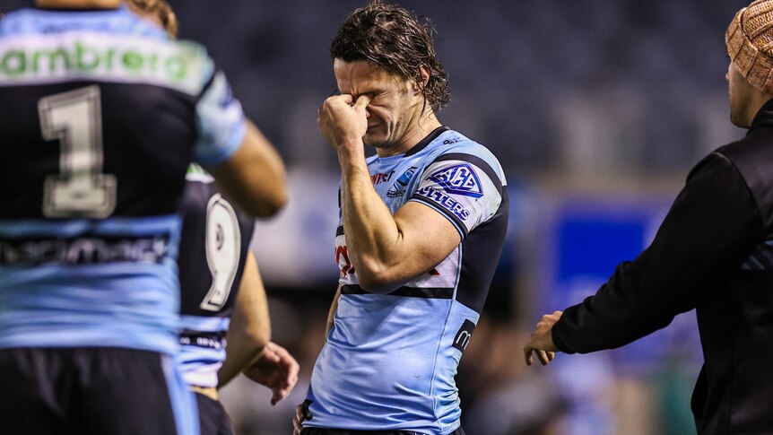 Nicho Hynes looks upset after the Sharks' NRL loss to the Dolphins.