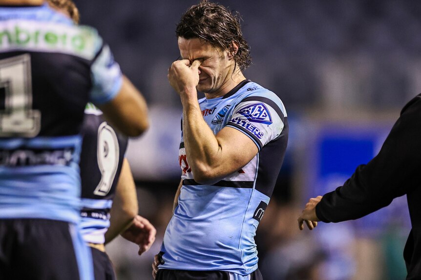 Nicho Hynes looks upset after the Sharks' NRL loss to the Dolphins.