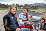 Sam and Alise Willoughby pose and smile together at a BMX track.