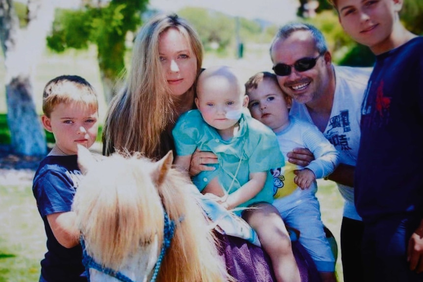 Perth boy Kai Nell sits on a Shetland pony surrounded by his family, including mother Kara Nell and father Richard.