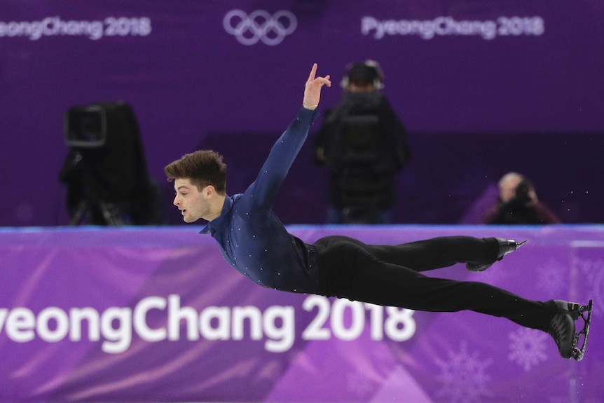 Brendan Kerry in mid-air as he competes in the figure skating at the 2018 Olympic Winter Games.