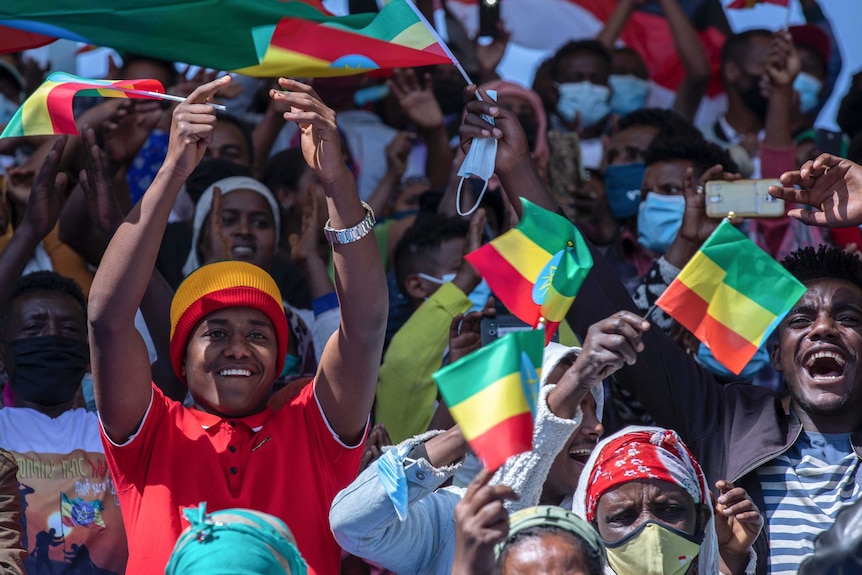 Ethiopians hold national flags at an event to honour the Ethiopian military