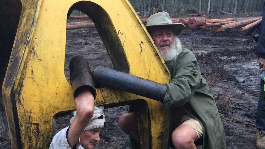 Protestors lock themselves onto machinery to try to stop logging in Gibberagee State Forest, NSW