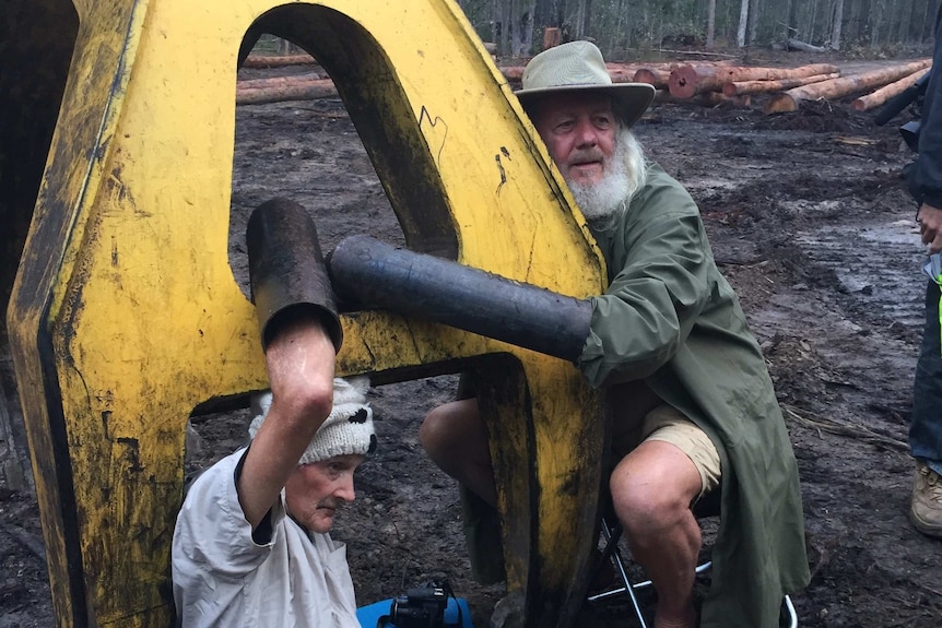 Protestors lock themselves onto machinery to try to stop logging in Gibberagee State Forest, NSW