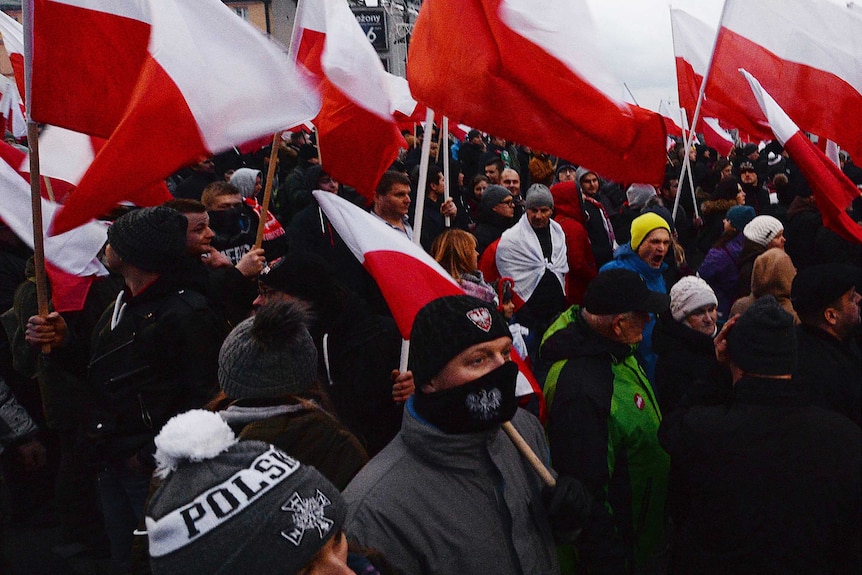 Demonstrators wave Polish flags at a nationalist rally on Independence day.