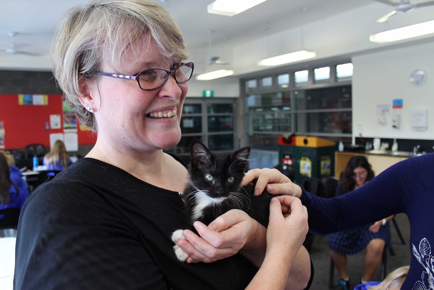 Kath Crawford from Flossie's Kitten Rescue holding tiny kitten