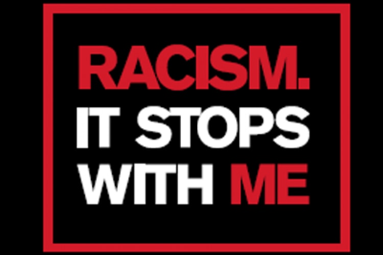A graphic with the words, "Racism, it stops with me" in red and white capital letters on a black background