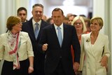 Prime Minister Tony Abbott and fellow MPs arrive at Parliament House