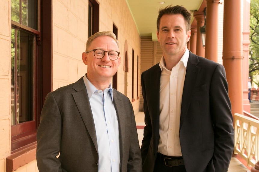 Two men in suits standing together.