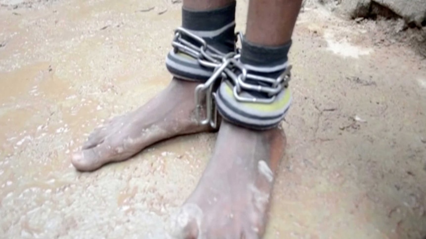 Chains are wrapped around a persons ankles.