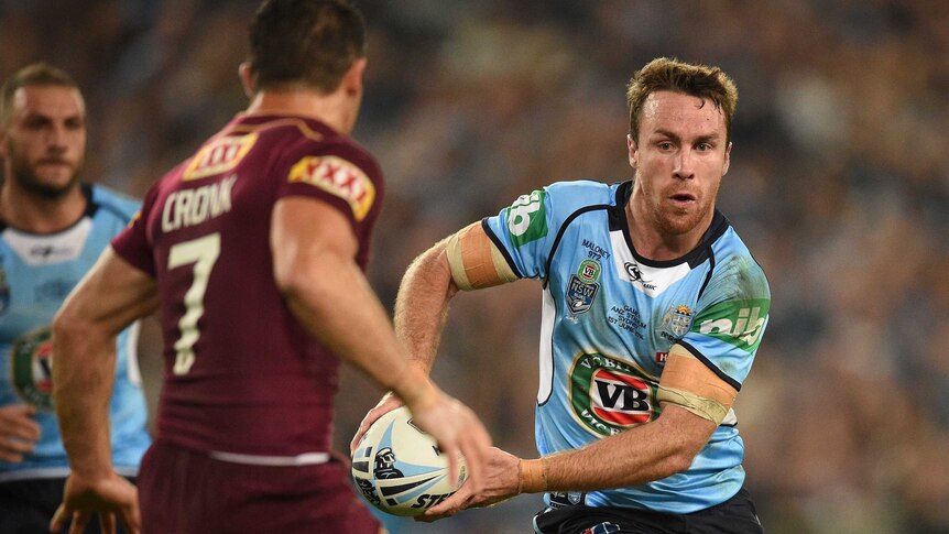 The Blues' James Maloney (R) looks to pass the ball during State of Origin I against Queensland.