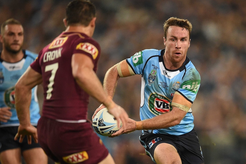 The Blues' James Maloney (R) looks to pass the ball during State of Origin I against Queensland.