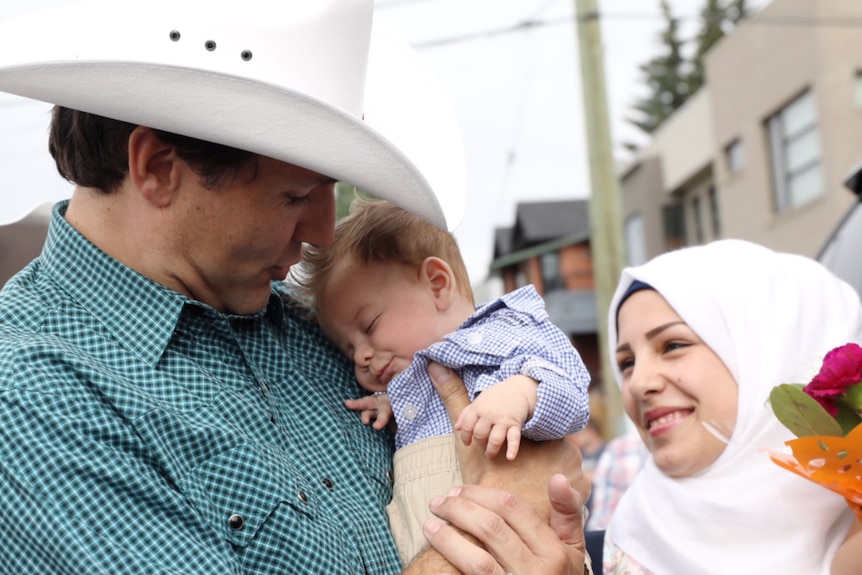 Canadian Prime Minister Justin Trudeau holding a baby named after him.