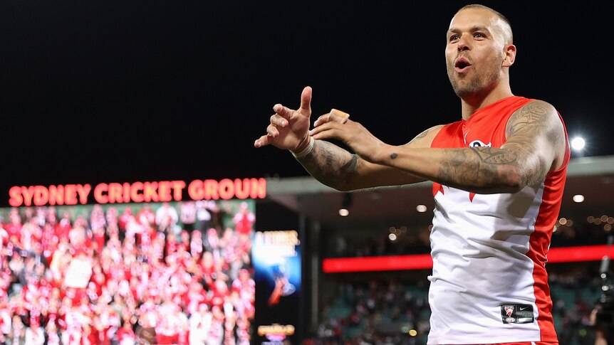 Sydney AFL star Lance Franklin calls out and holds his hands to the crowd in celebration after a finals win for Sydney Swans.