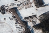 This satellite images provided by Maxar Technologies shows a troop housing area and vehicle park.