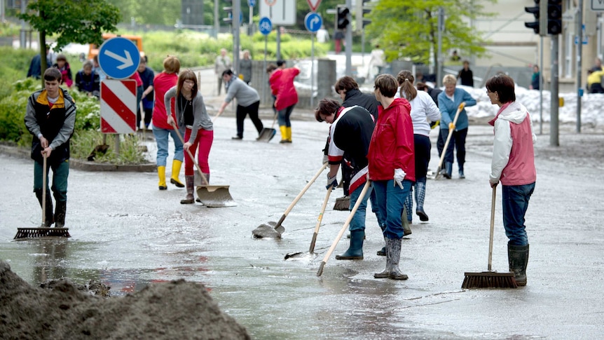 Residents clean the streets in Greiz, eastern Germany.