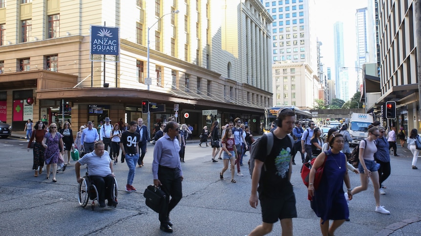 A busy Brisbane CBD scramble crossing at intersection of Adelaide and Edward streets, before coronavirus restrictions kicked in.