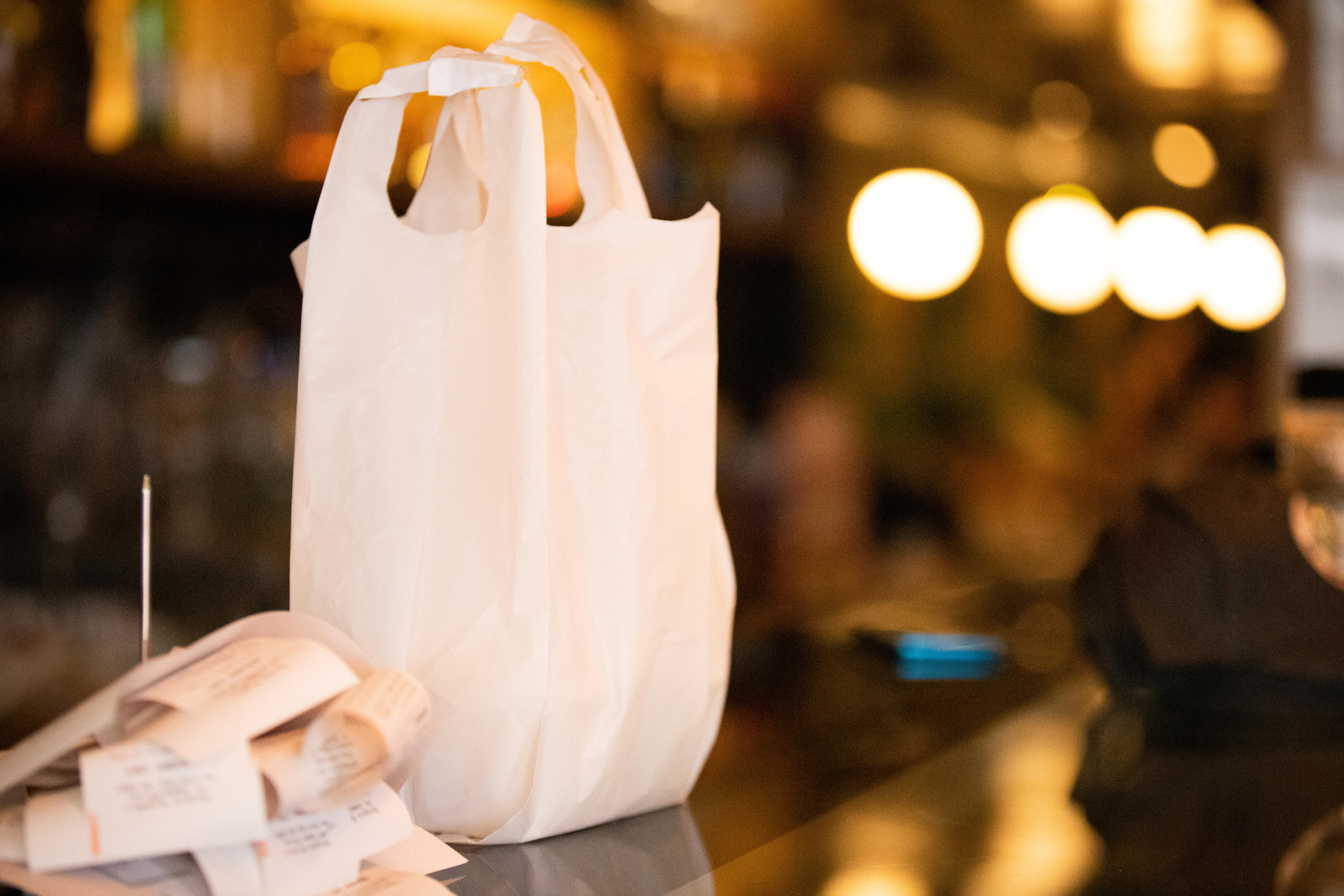 A white plastic bag on a restaurant counter.