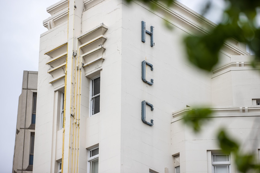 The letters HCC are visible in a close-up image of the Hobart City Council building. 