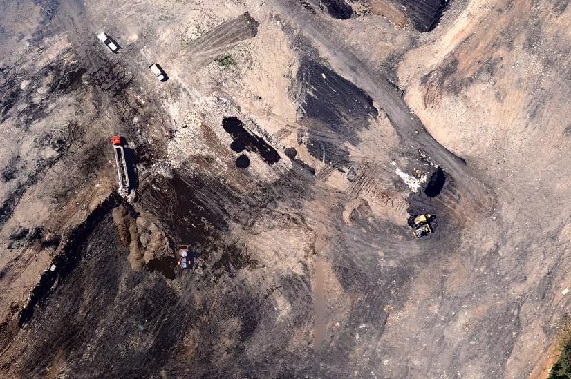 An aerial shot of a former mine site showing the depositing of landfill.