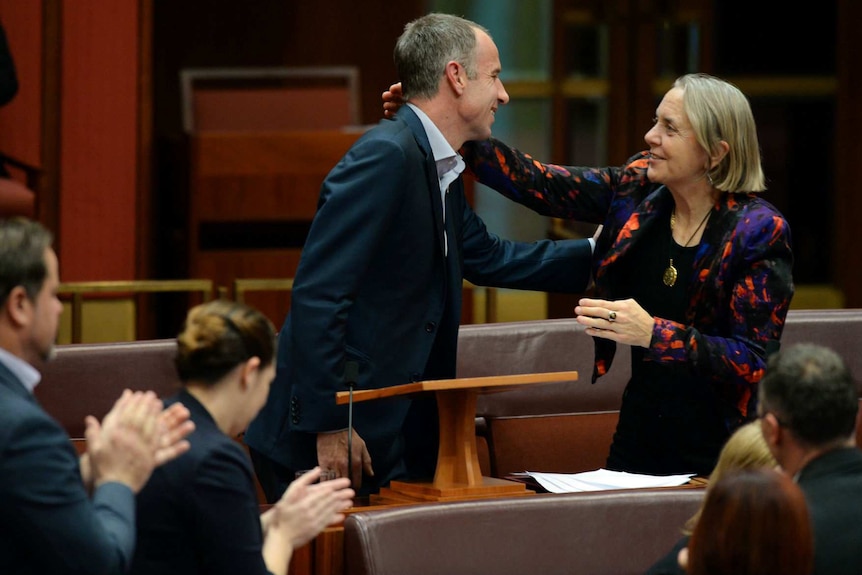 Australian Greens Senator Nick McKim (centre) is congratulated by fellow Australian Greens Senator Lee Rhiannon.