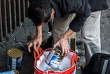 A man packs a bag with baby formula in China
