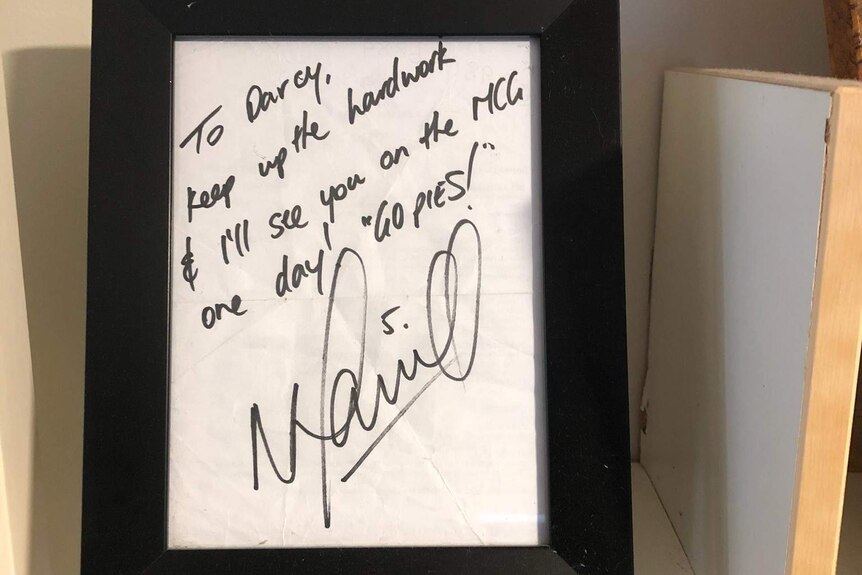 A framed letter from Nick Maxwell on a shelf