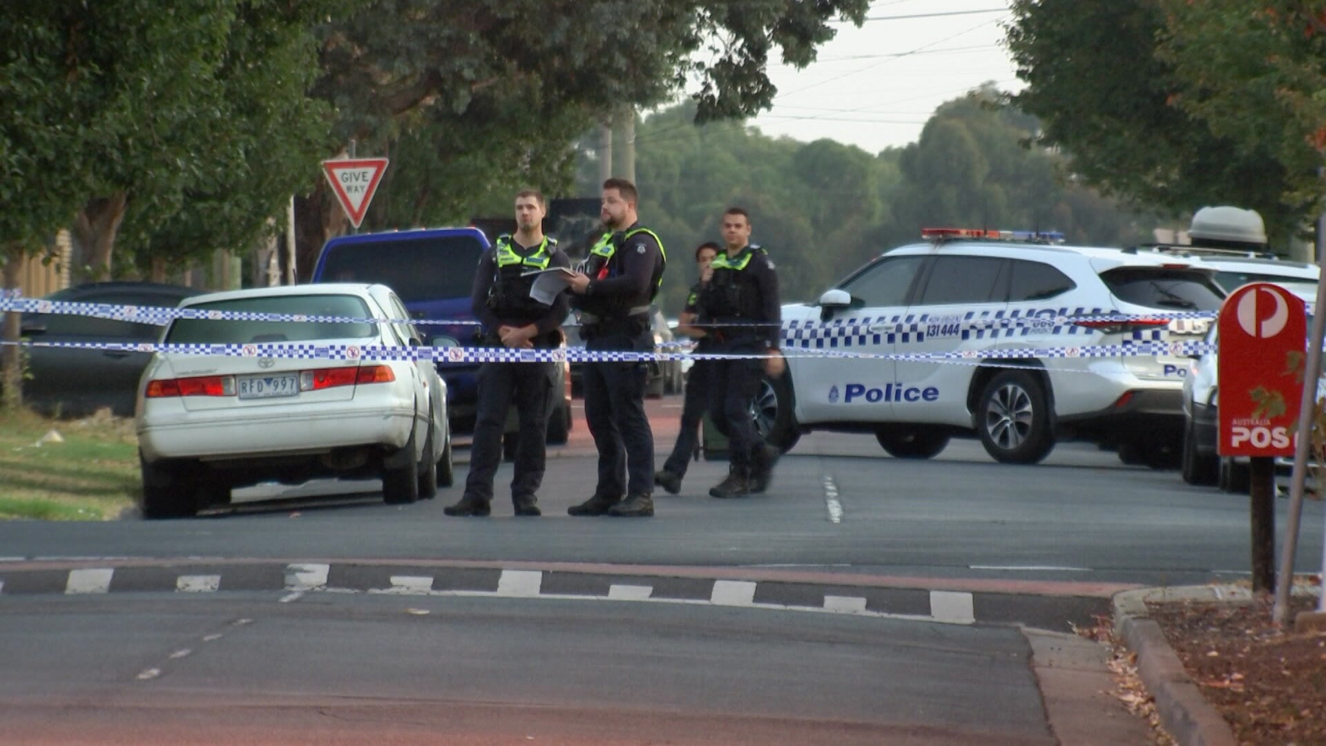 Police standing in a street.